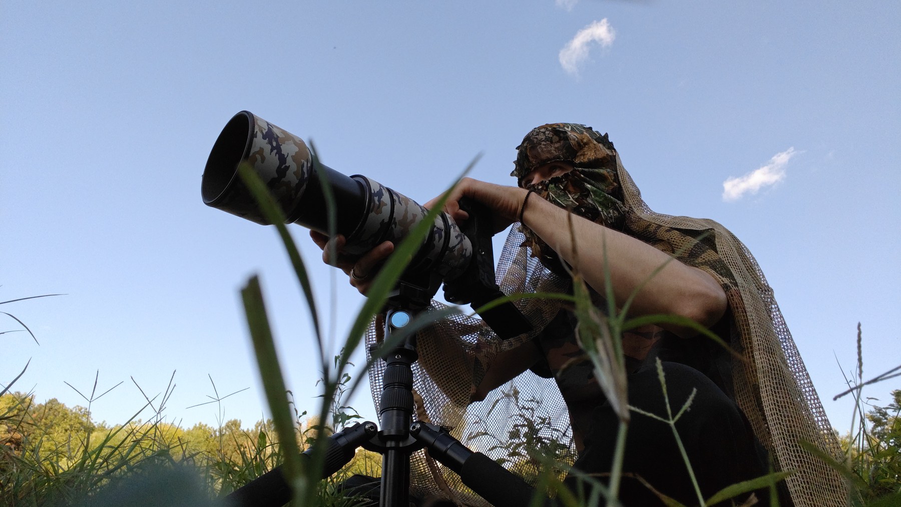 Nick using a camouflaged telephoto camera from ground level